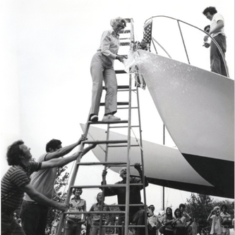 Rogue Wave is christened outside Gougeon Brothers Boatworks.